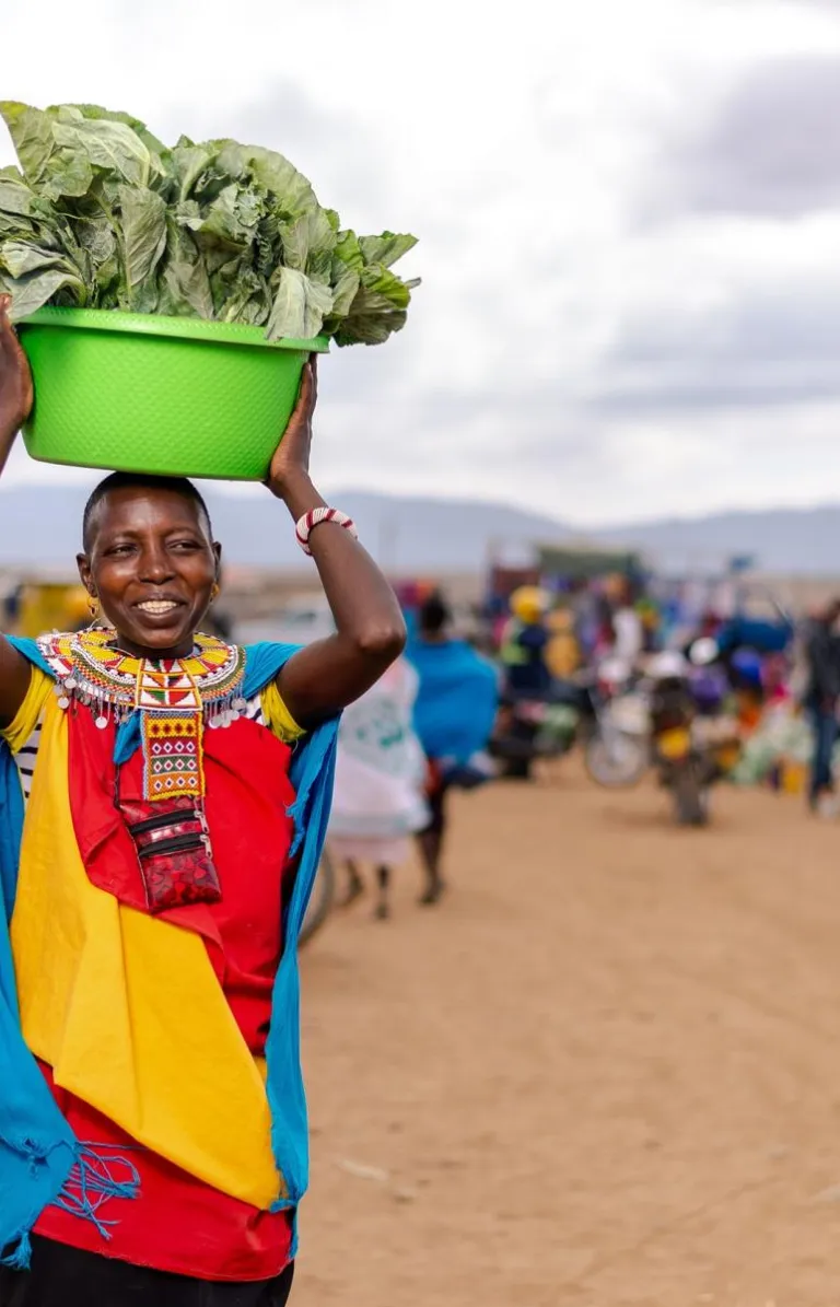 woman carrying bowl of lettuce